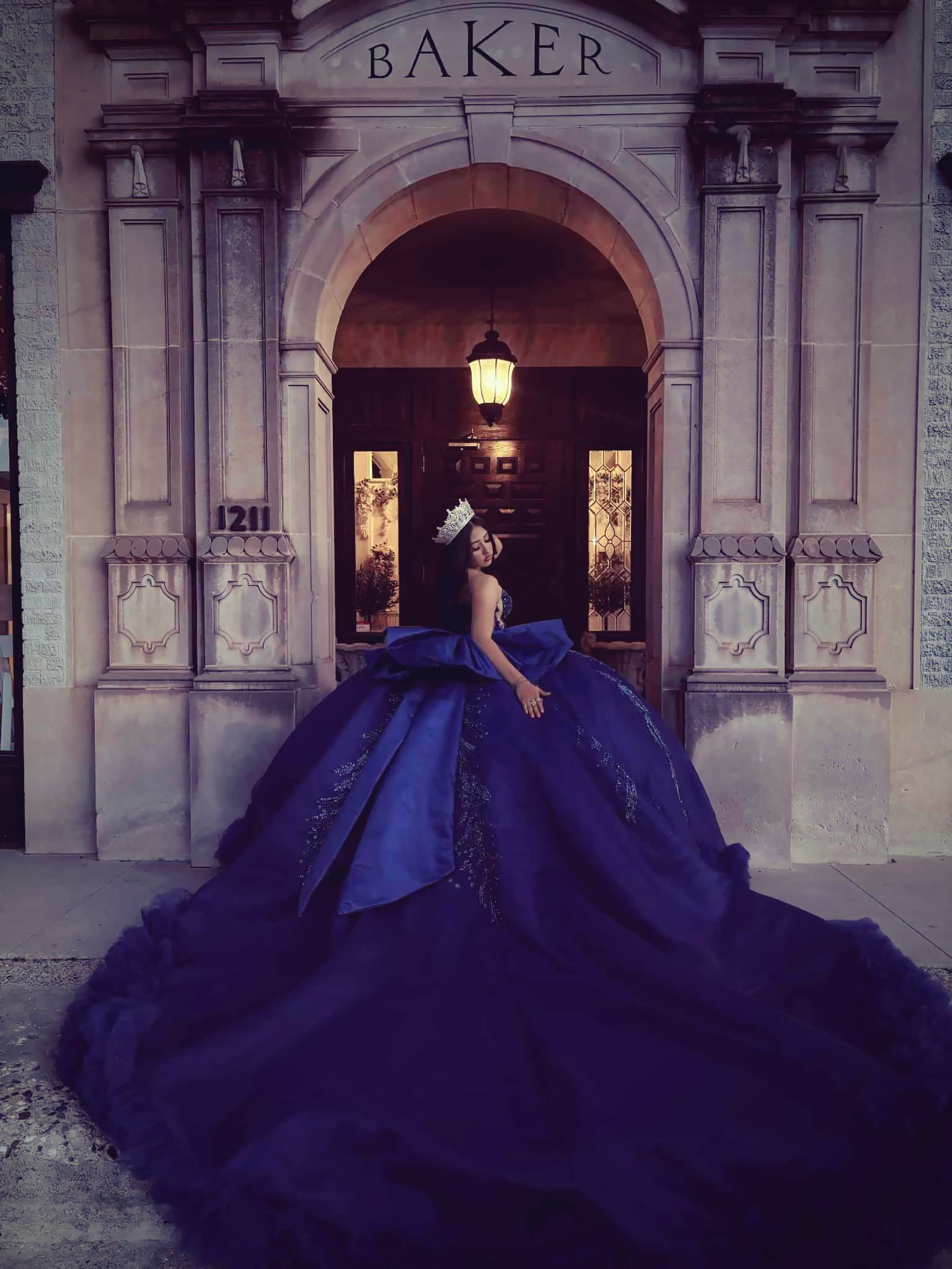 Formal blue gown portrait at the entrance of The Historic Baker Building